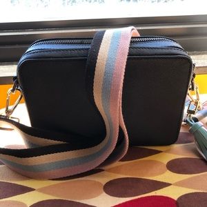 Saint + Sofia leather camera bag with off brand strap and tassel.